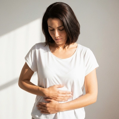 Woman holding her midsection, illustrating hormonal balance and well-being