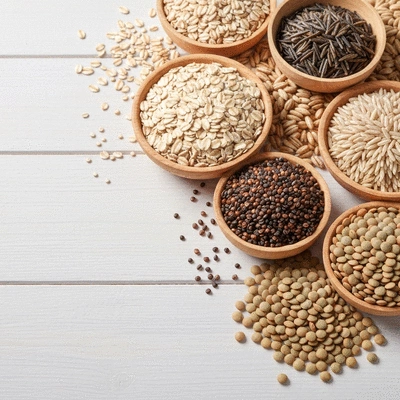 A variety of whole grains and legumes, such as oatmeal, quinoa, lentils, and wild rice, arranged neatly